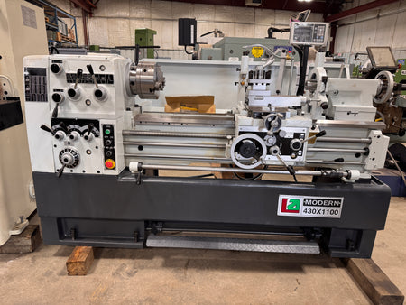 Metal lathe machine with 'Modern Machine' branding in an industrial setting