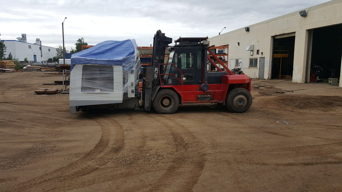 Industrial machinery moving truck transporting CNC equipment in Alberta