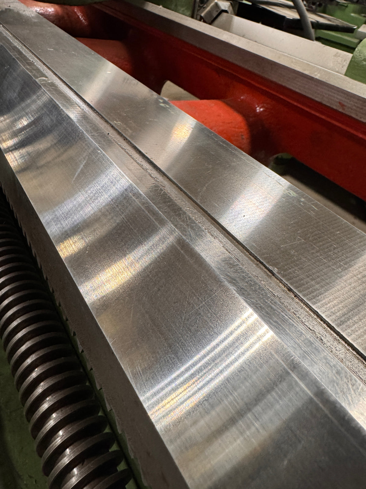 alt="Restored lathe bed ways after scraping with smooth corrected geometry"