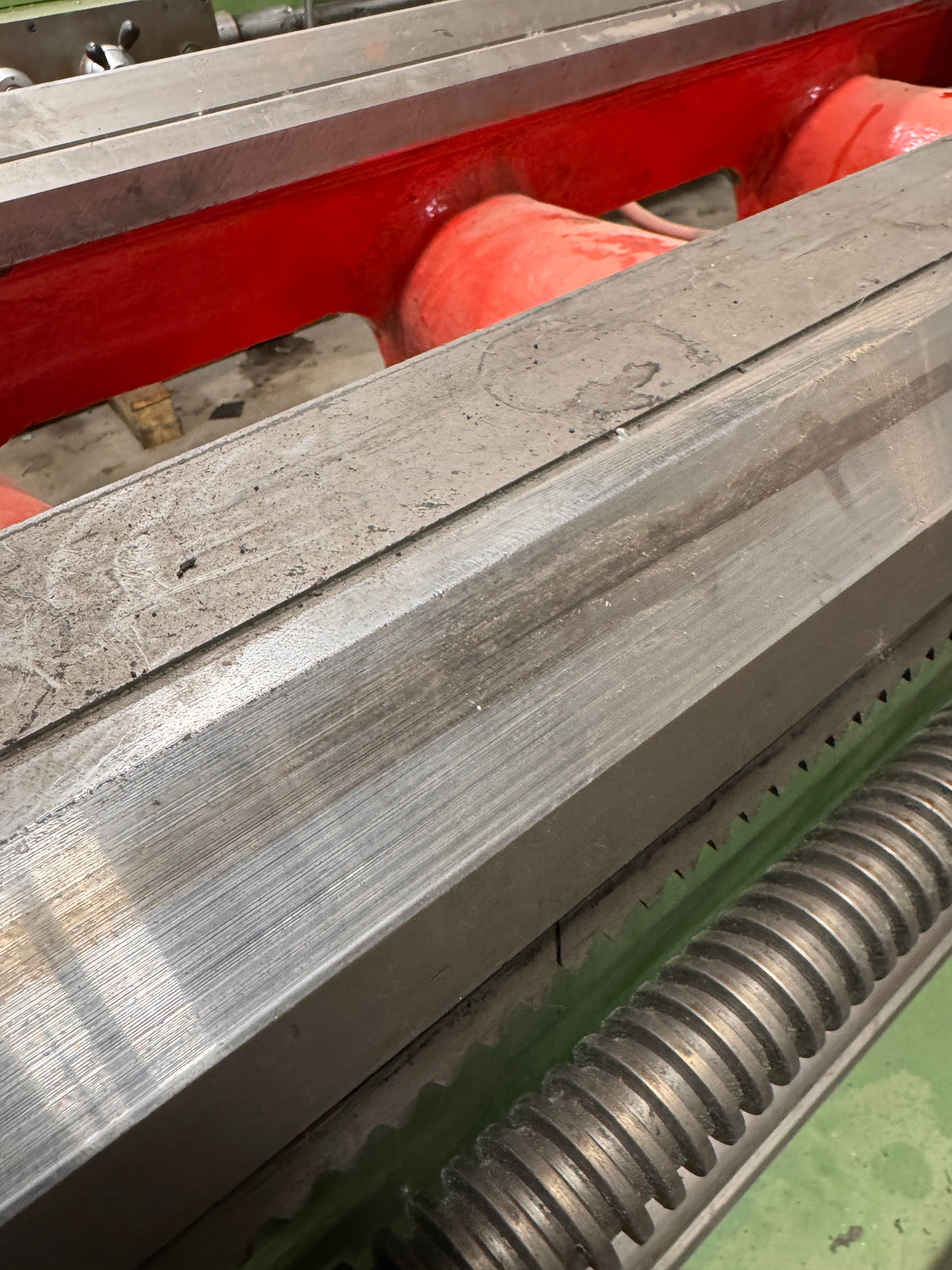 alt="Worn lathe bed ways before rebuilding showing uneven wear and poor contact"