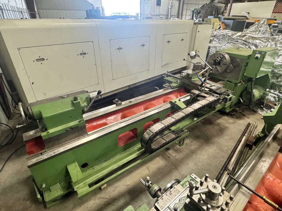 Green industrial machine in a workshop setting lathe