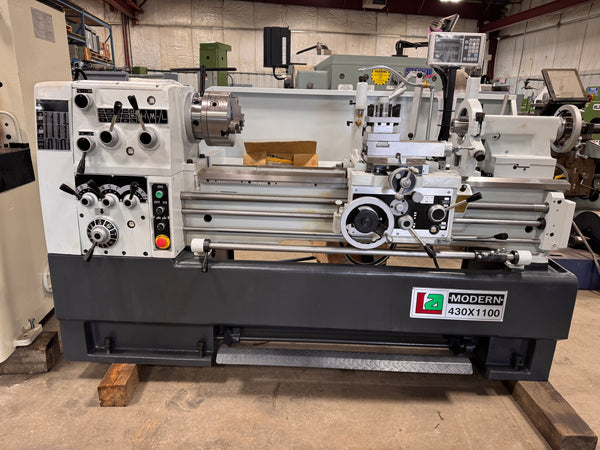 Metal lathe machine with 'Modern Machine' branding in an industrial setting