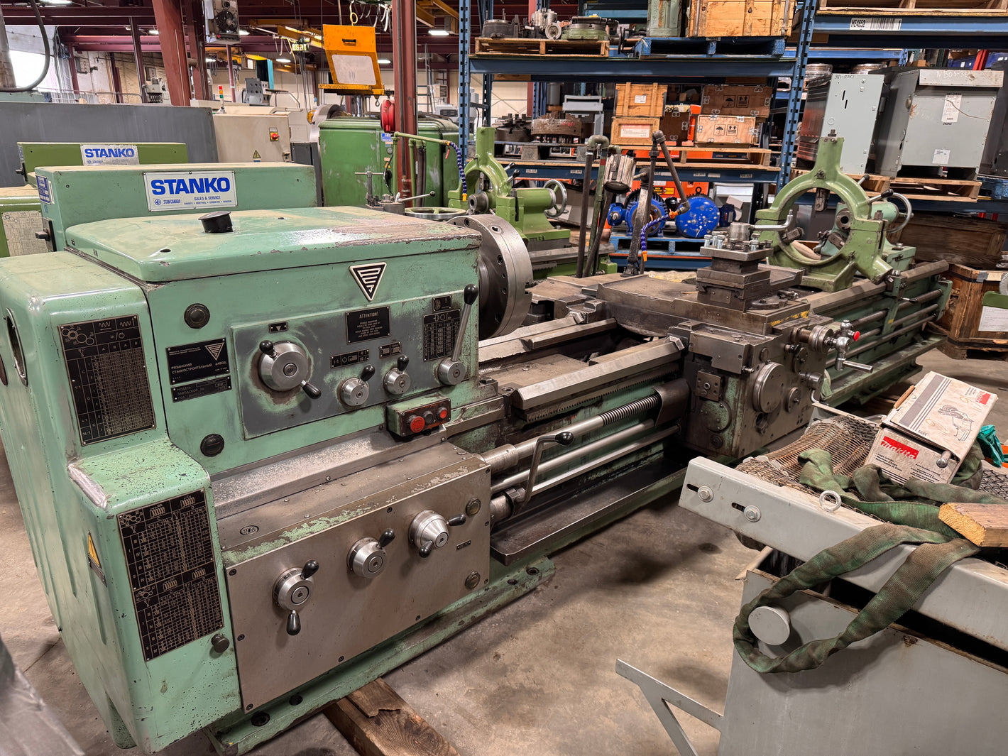 Stanko 1M63B engine lathe with 28" swing and 120" centers, 3-jaw chuck, taper attachment, and steady rest - Modern