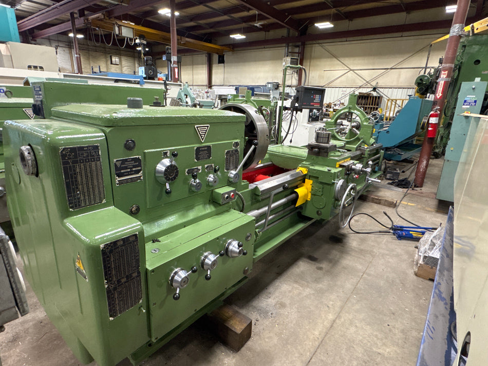 Green industrial lathe machine in a workshop setting Stanko 1M63B manual lathe with 40-inch swing, 100-inch centers, and 20-inch 4-jaw chuck – Modern